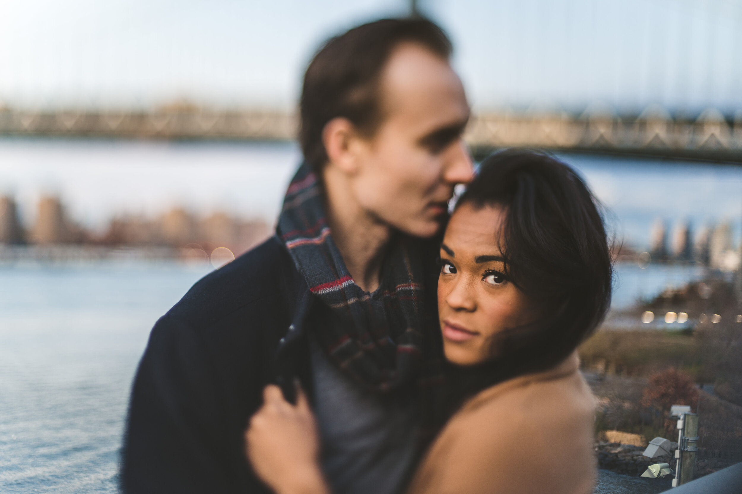 Tapoa and Anders kissing in DUMBO during their pre-wedding engagement photography session.