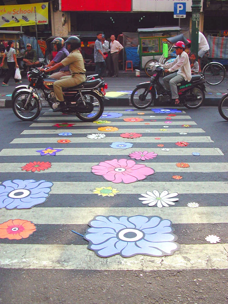 Motorcycles driving over flowers.jpg