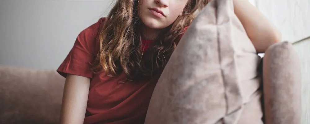 Close up of a teen with an upset expression, represents how teenage therapy in Los Angeles, CA can provide the support your teen needs.
