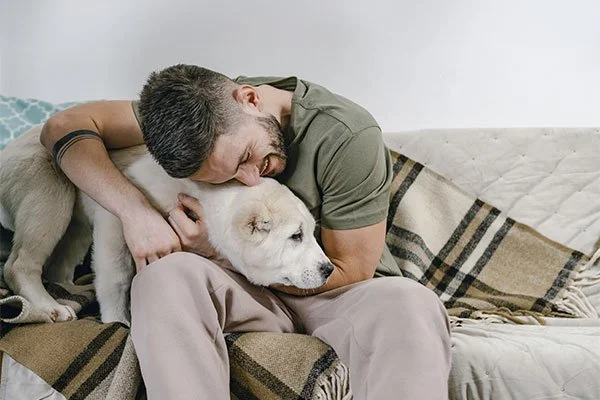 Man hugging his dog, represents how depression treatment in Los Angeles, CA can help you begin your healing journey.