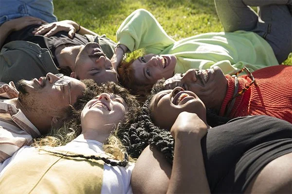 Group of friends laughing together, represents how internal family systems therapy can help you reconnect with yourself and others in your life.