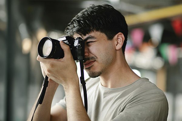 Men taking photos, represents how art therapy can take many forms of creative expression.