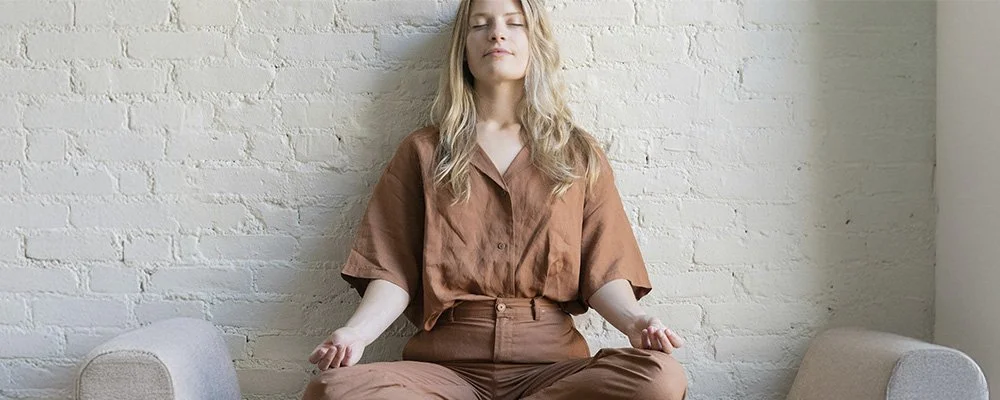Woman in a meditation pose, represents how holistic anxiety treatment in Los Angeles can help you fell grounded and connected.
