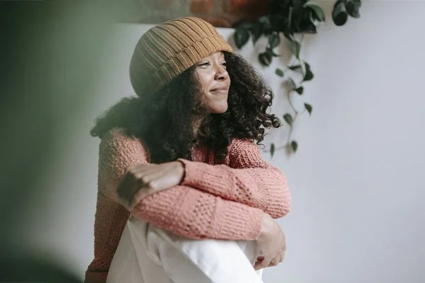 Woman with an optimistic and calm expression, represents how trauma therapy in LA can help you overcome trauma challenges.