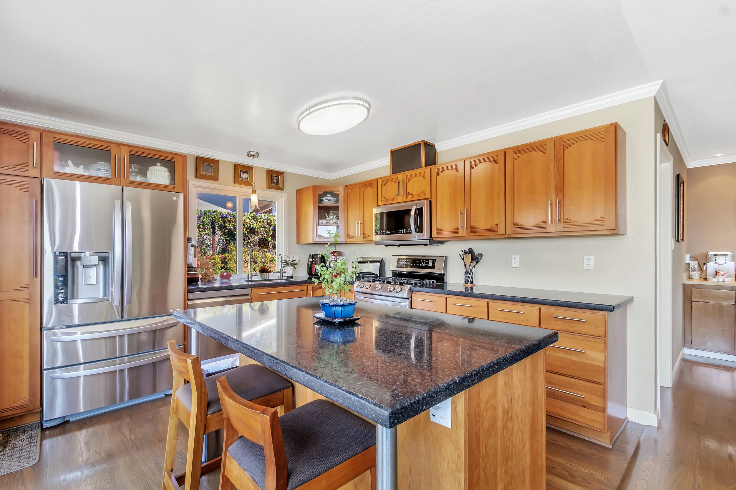 Recently remodeled kitchen features Stainless Steel LG appliances, black Silestone counters and Cherrywood cabinets.