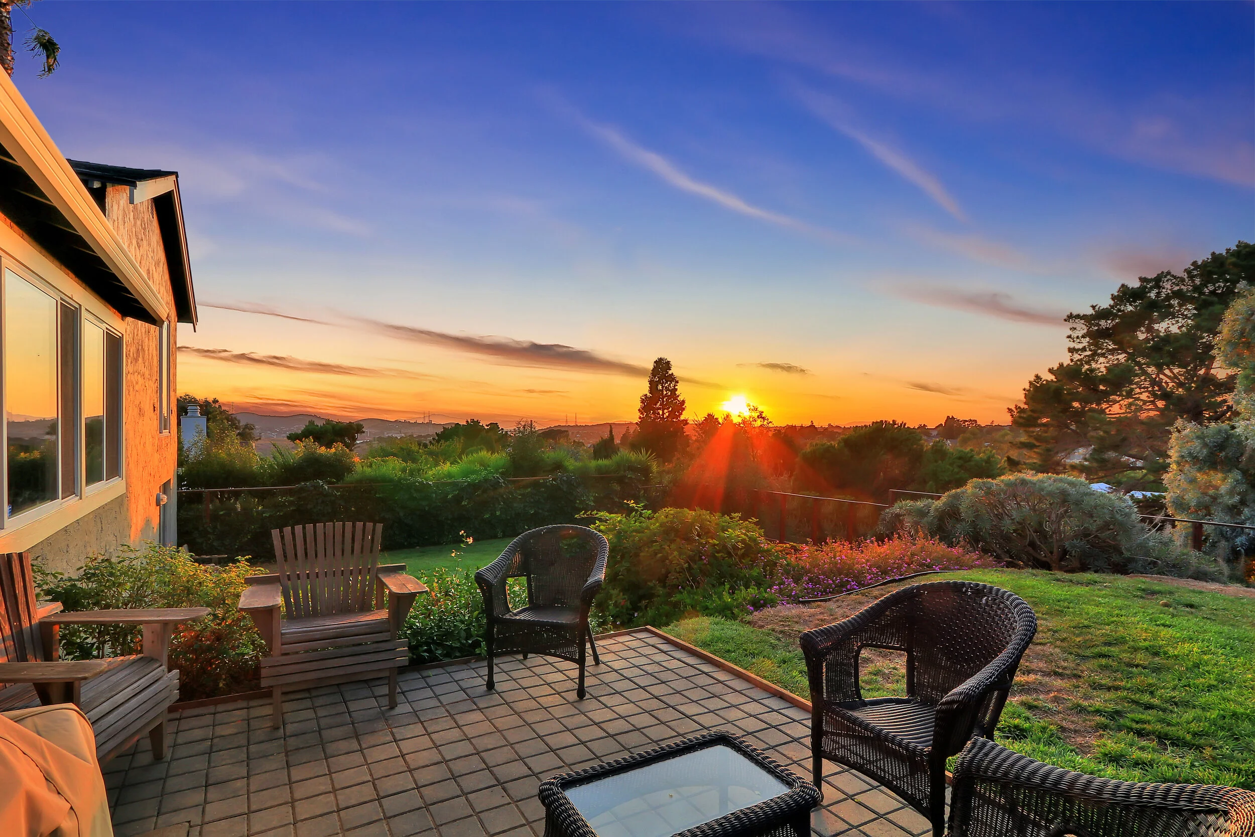 The backyard is beautifully landscaped with mature trees and water & bridge views..
