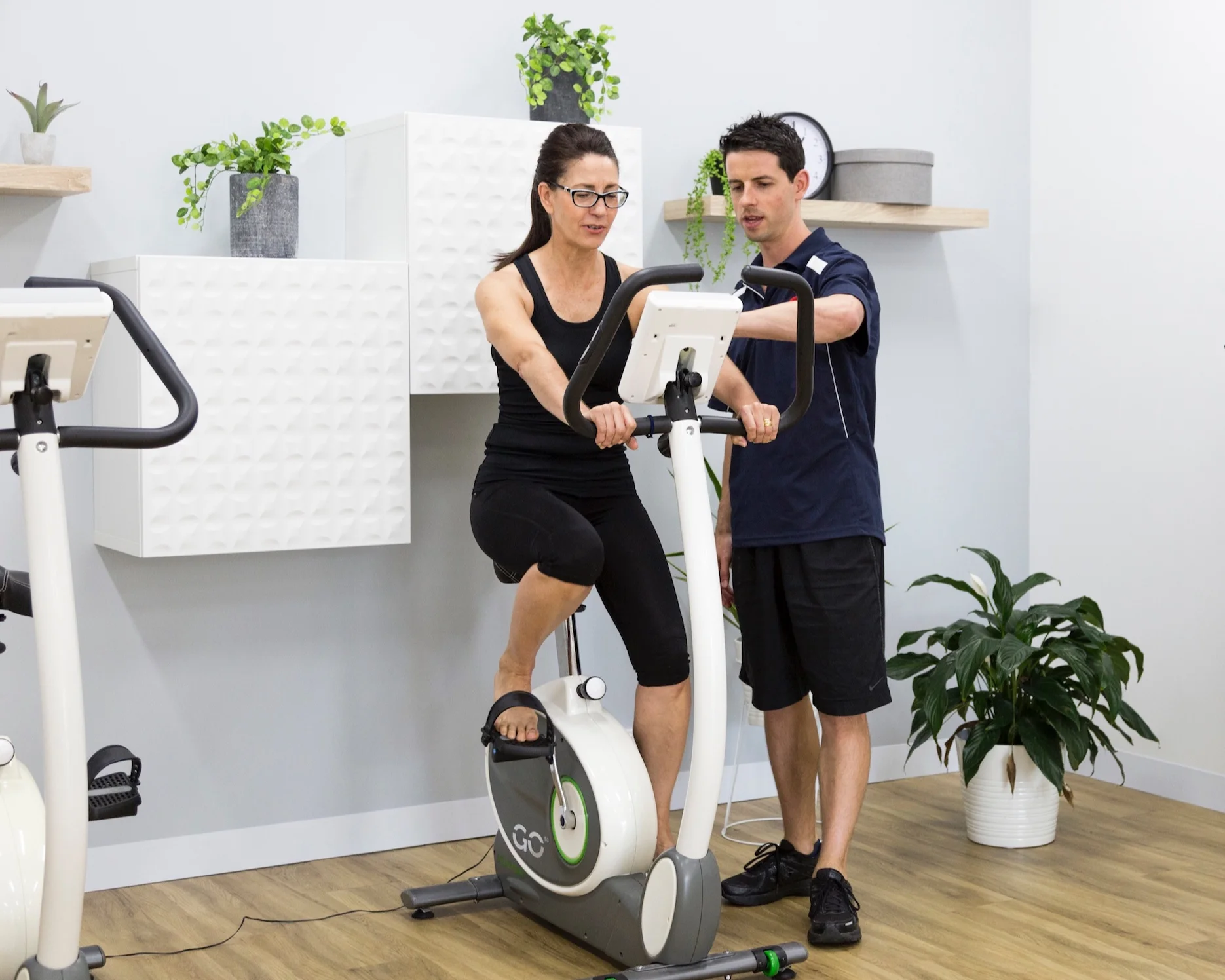 Robbie Webb, an expert manager in sports physiotherapy instructing the correct use of equipment in the exercise studio