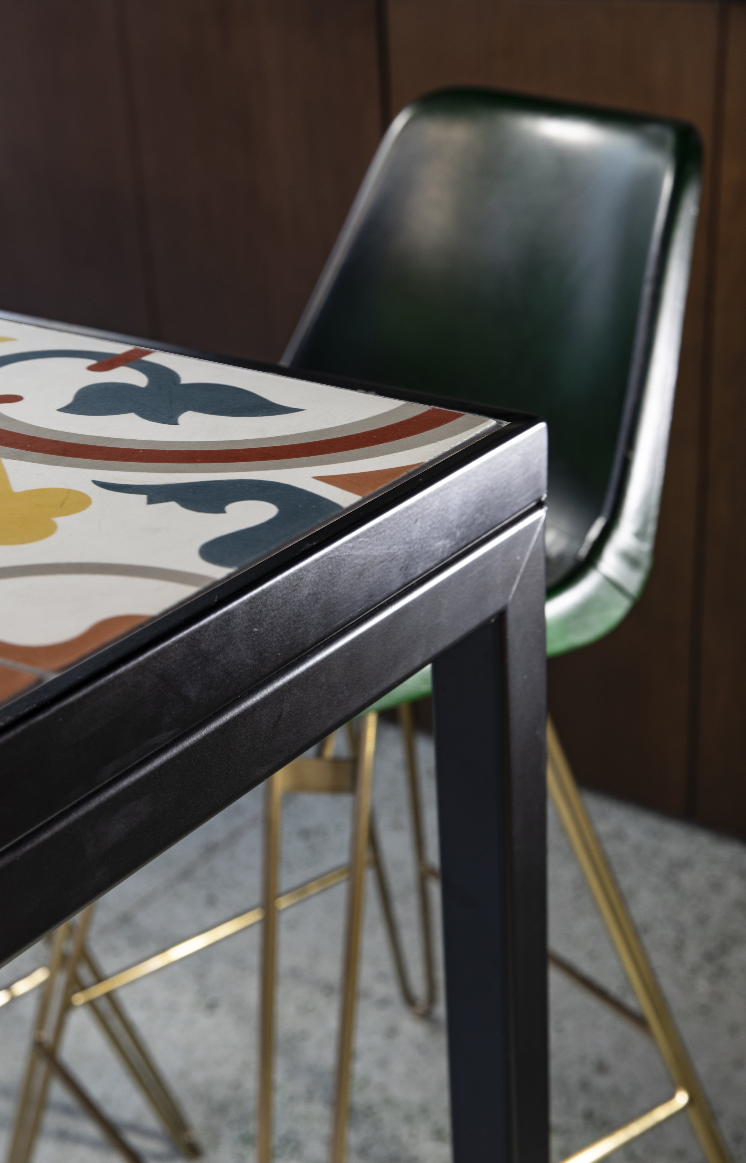 dark green leather chair and pattern tile table