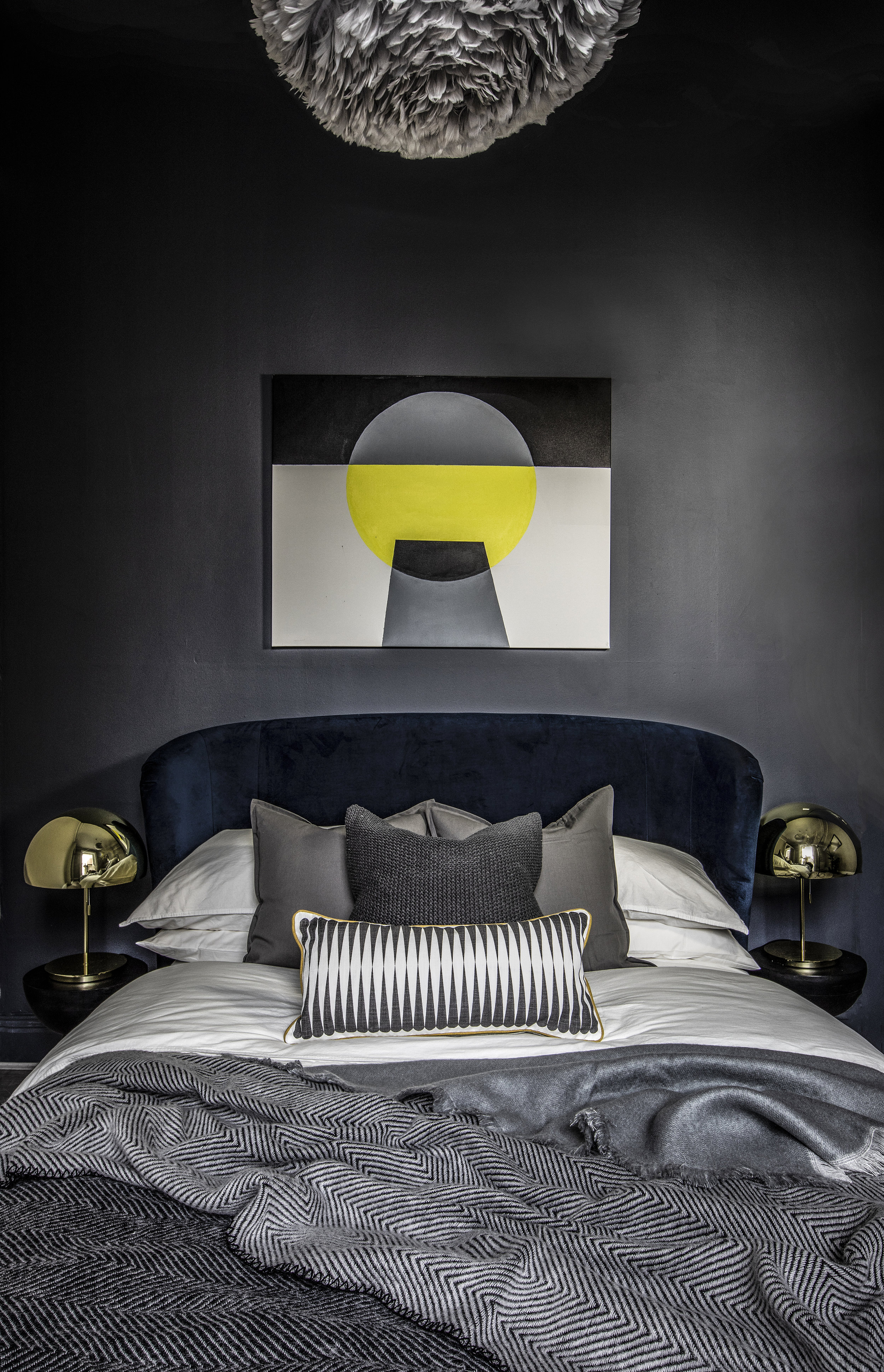 black, grey and yellow bedroom with modern art