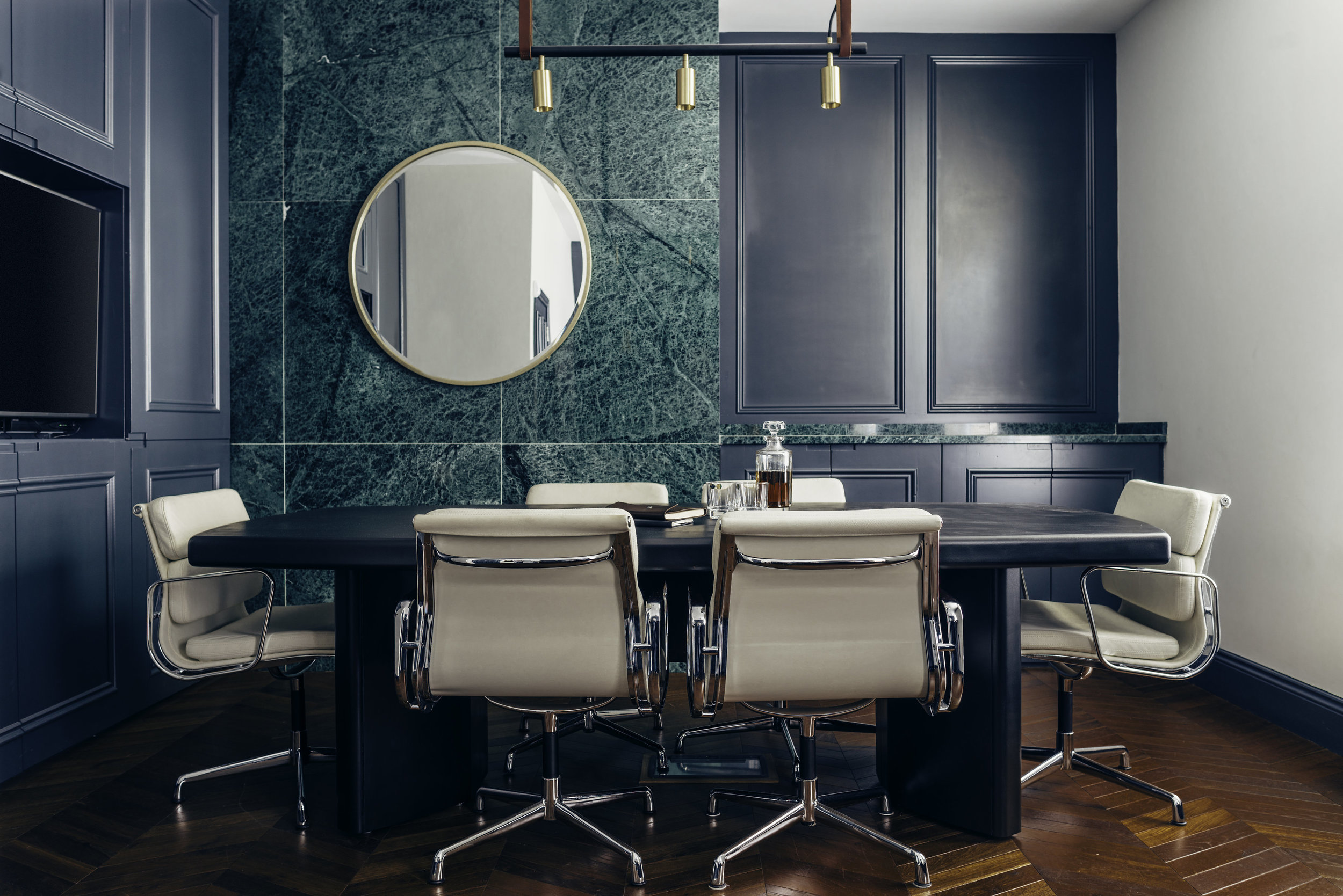 white leather chairs in aquamarine office circle mirror