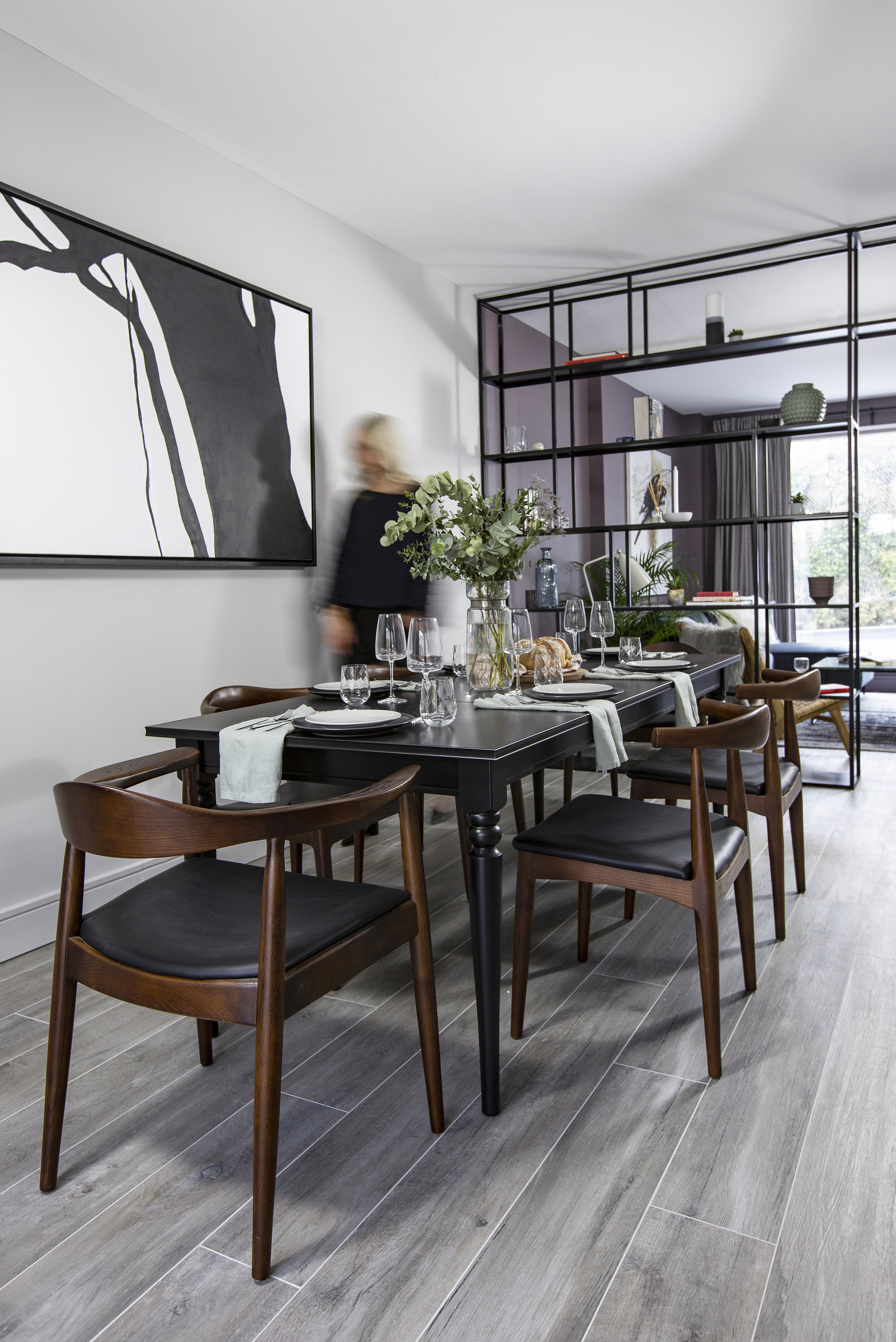 kitchen with grey floors and black and dark wood dining set