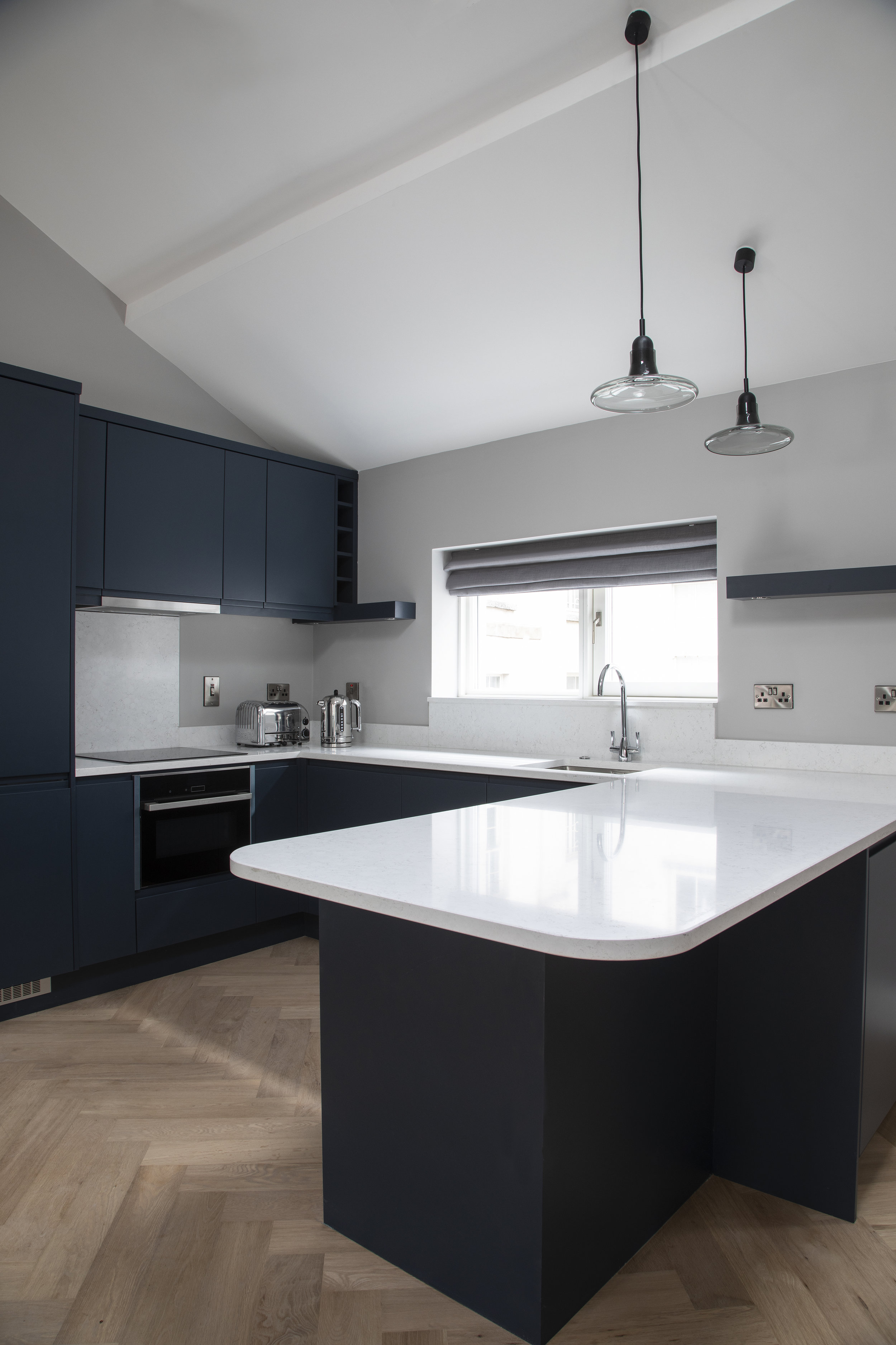 sleek sark blue kitchen white white counter tops