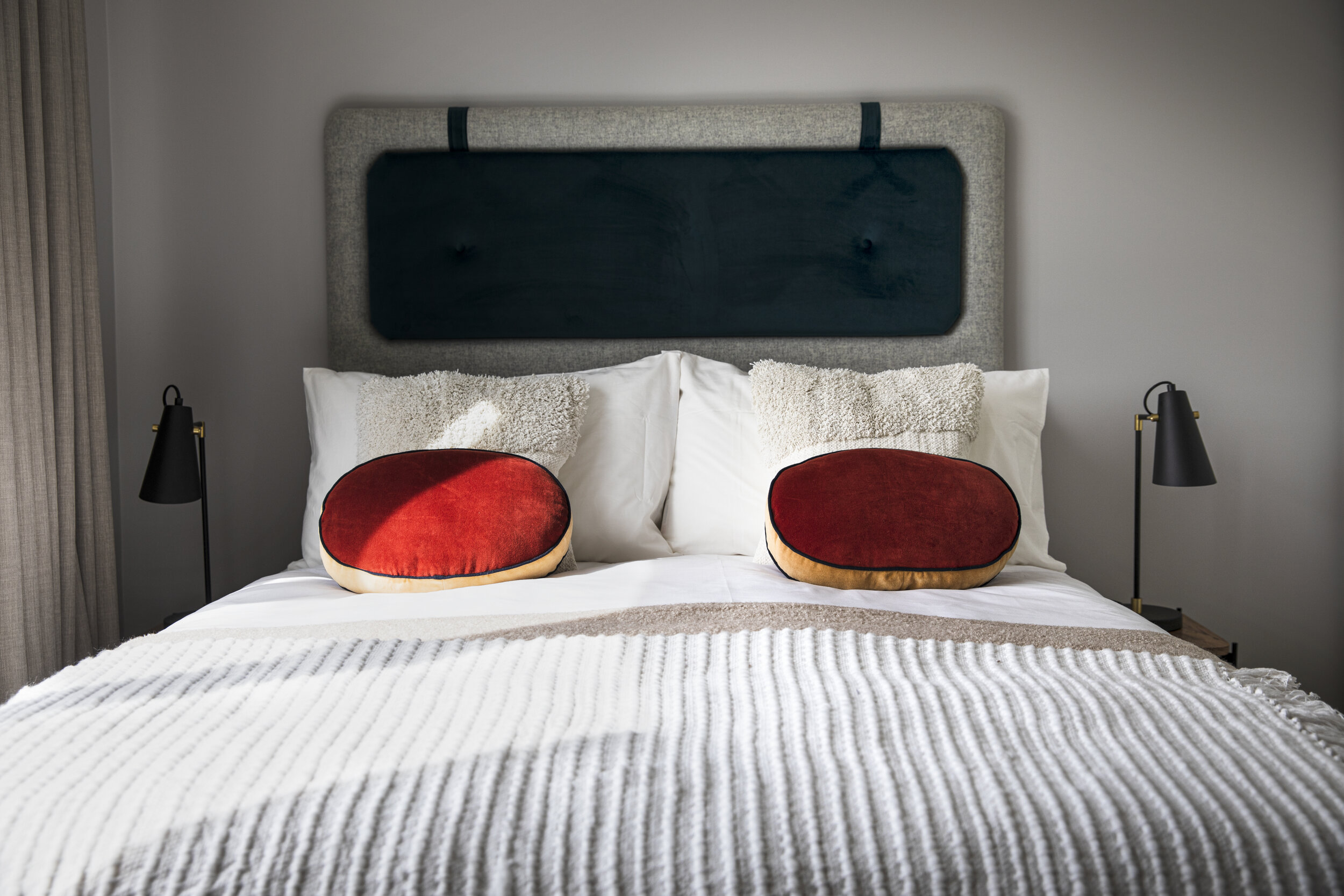 round red pillows on bed