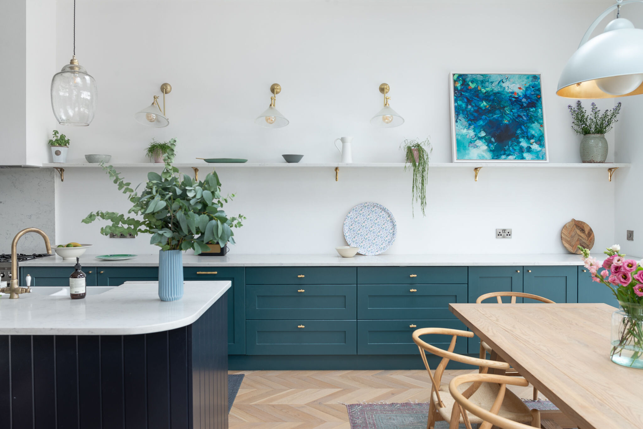 blue kitchen with floating shelf
