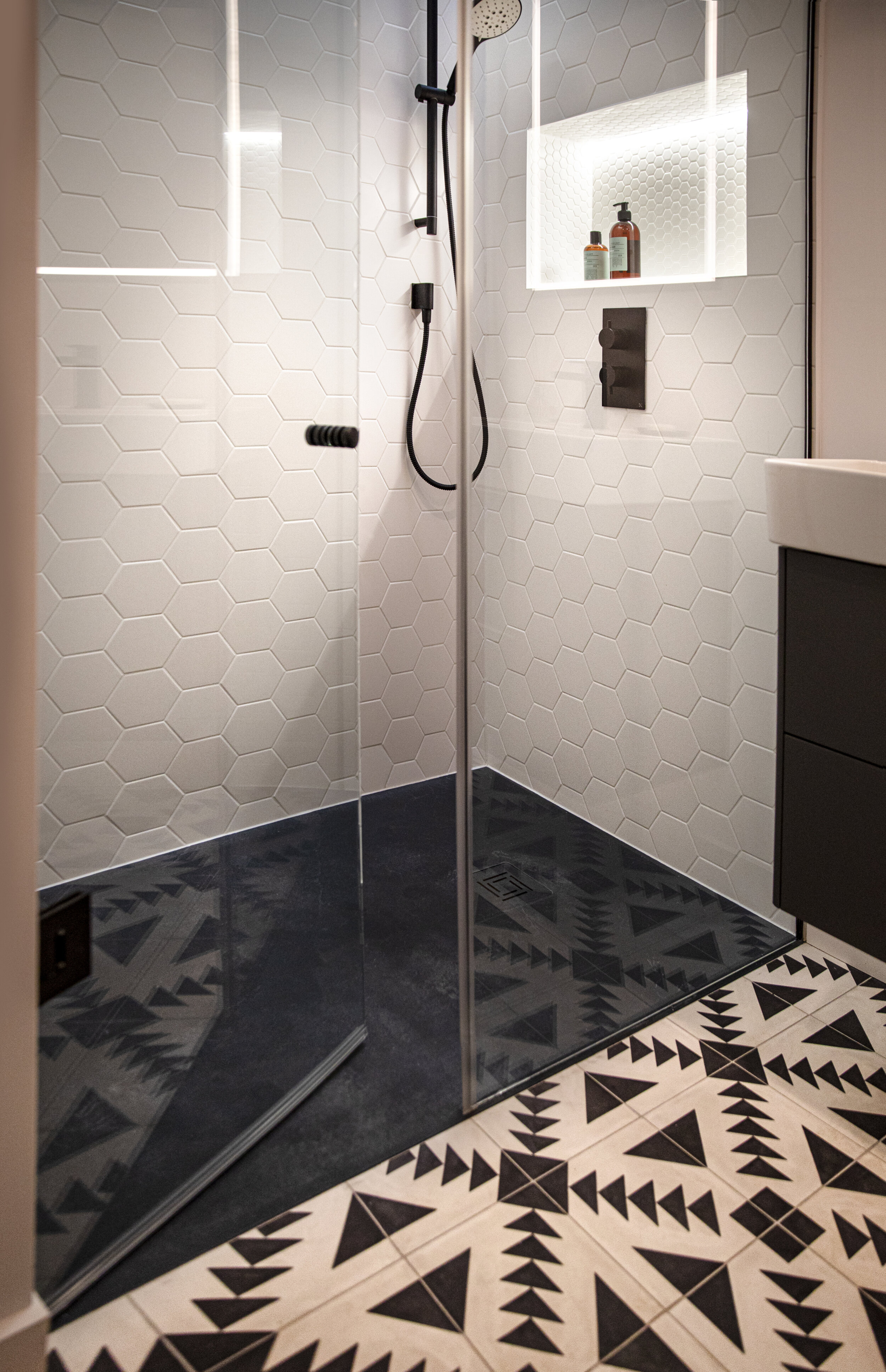 shower with blue floor and recessed shower shelf
