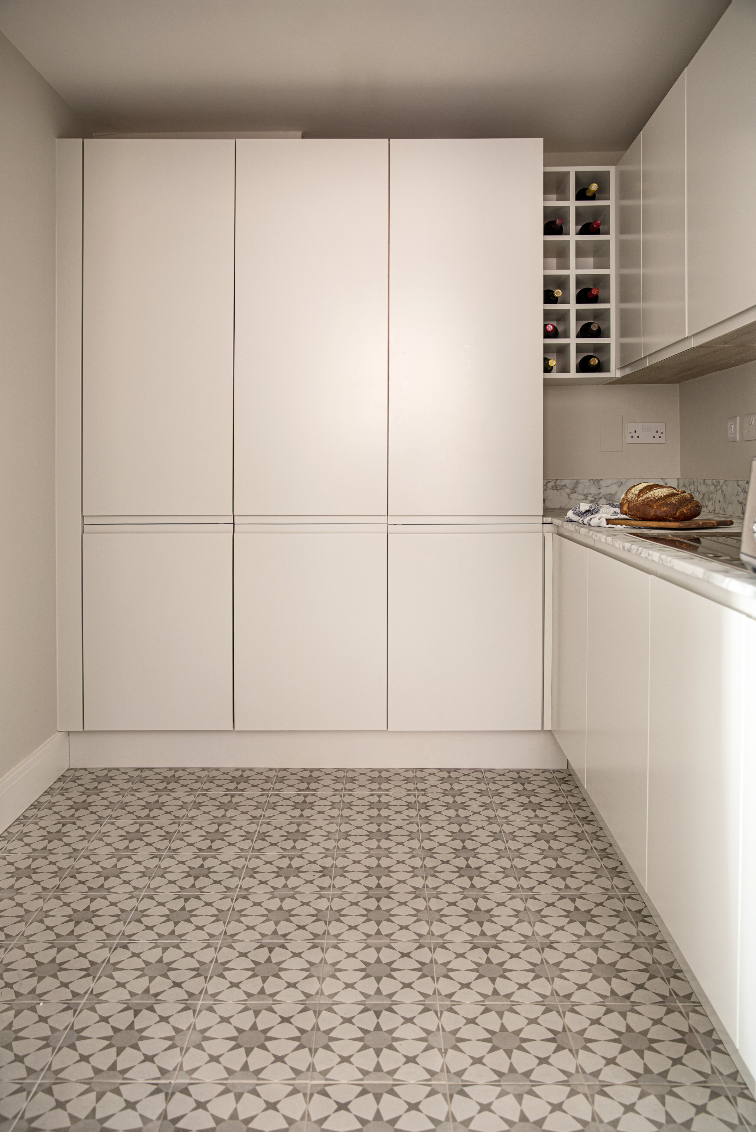 star tile kitchen floor and handless white cabinets