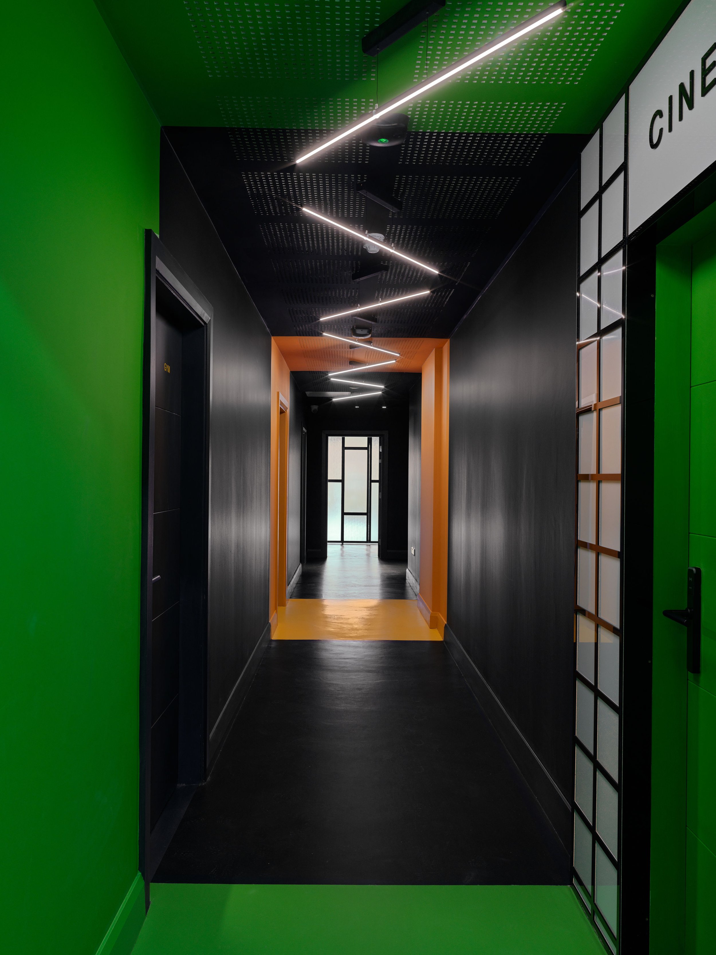black hallway with zigzag overhead strip lights