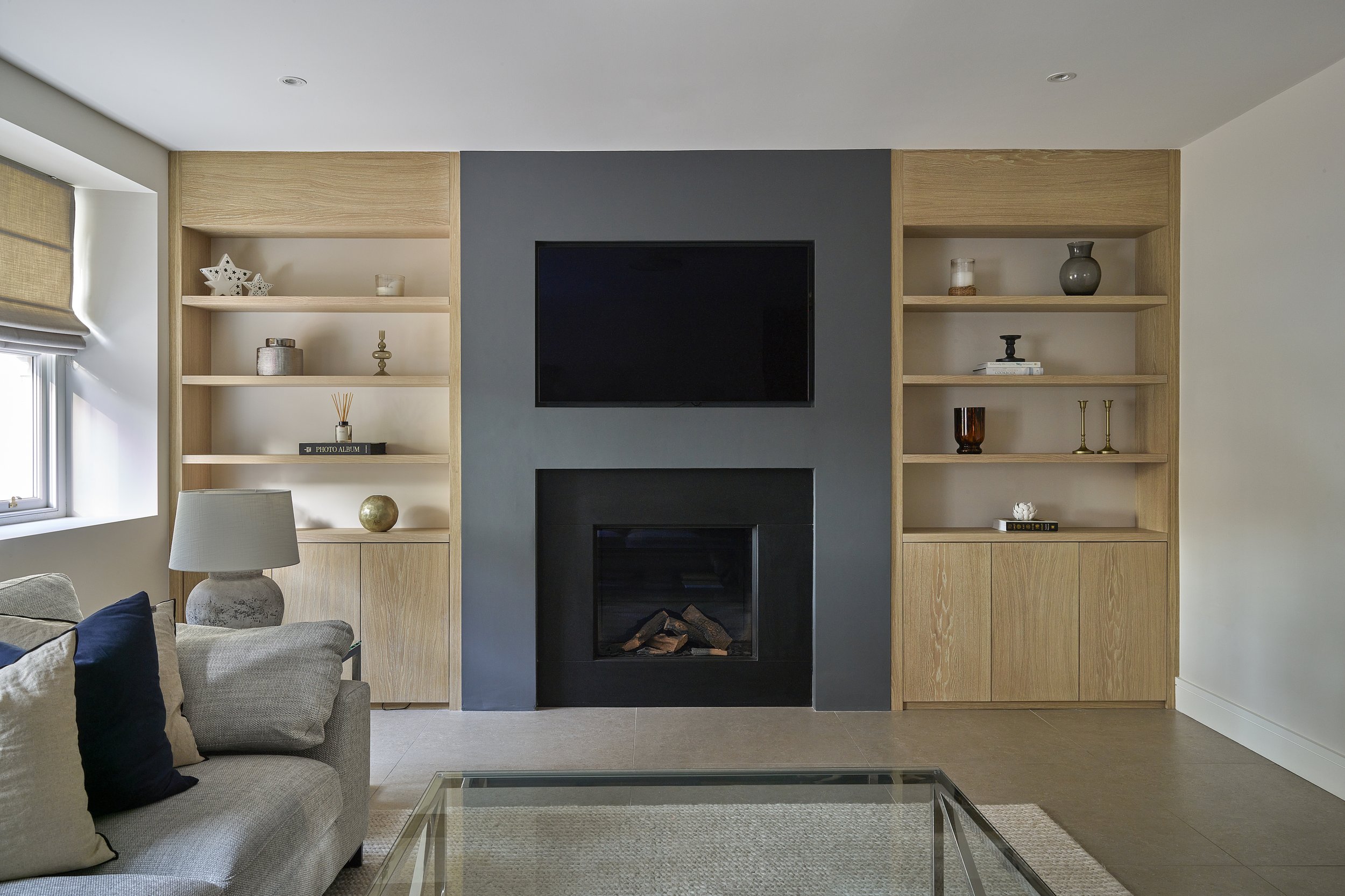 minimal living room with black stone fireplace