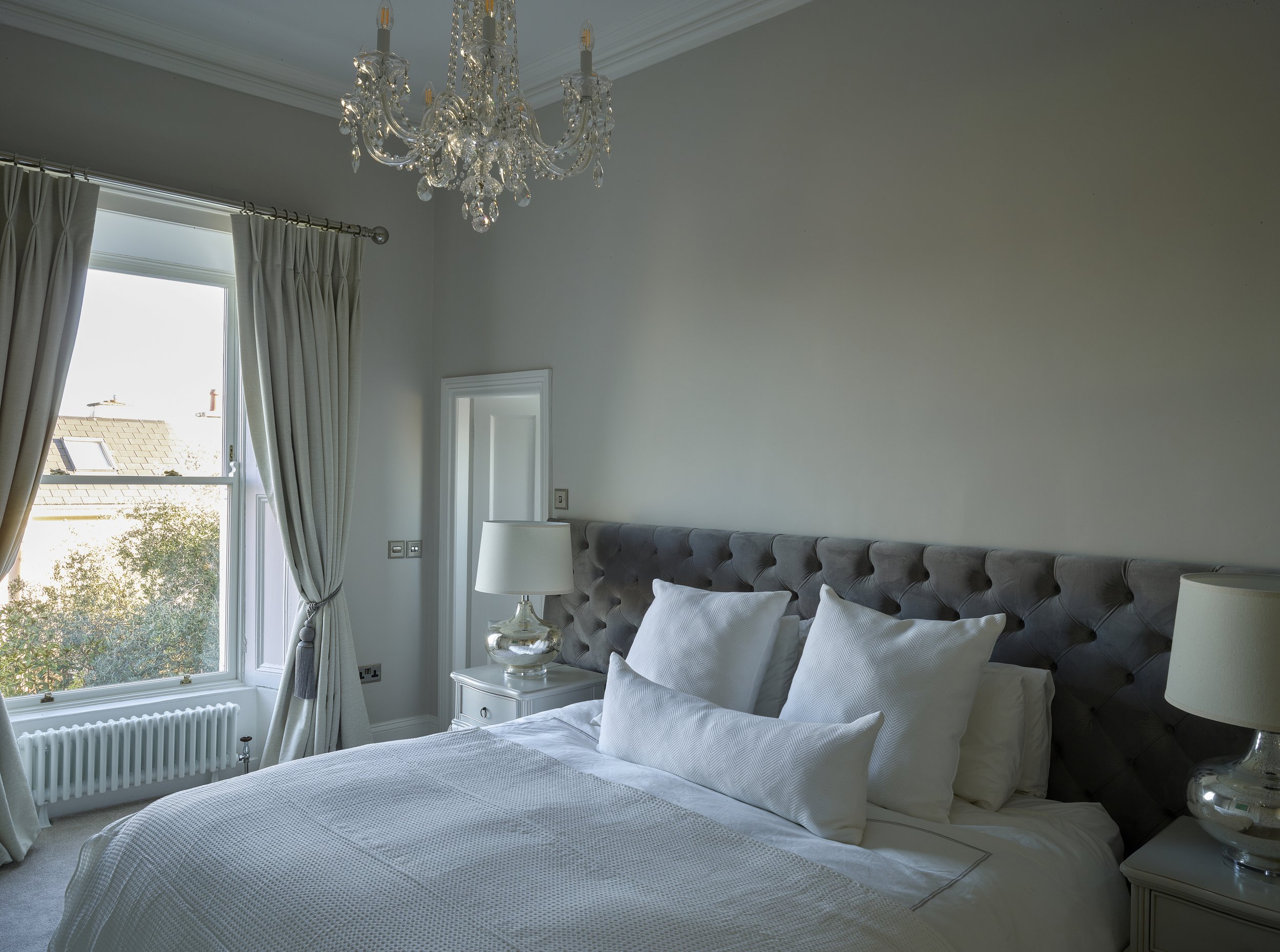 grey bedroom with chandelier