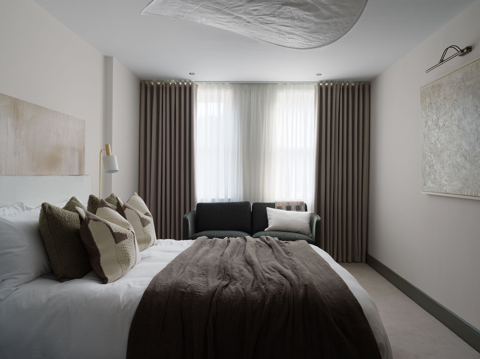 dark grey bedspread and floor length curtains 