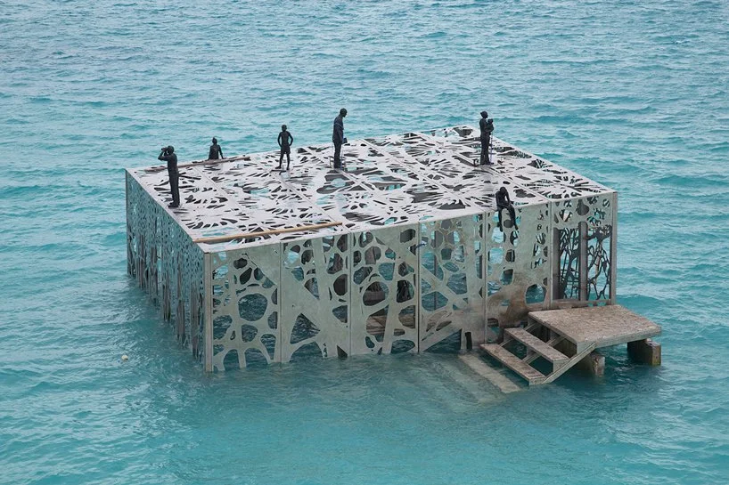 a staircase submerged in water leads snorklers to the museum image courtesy of jason decaires taylor