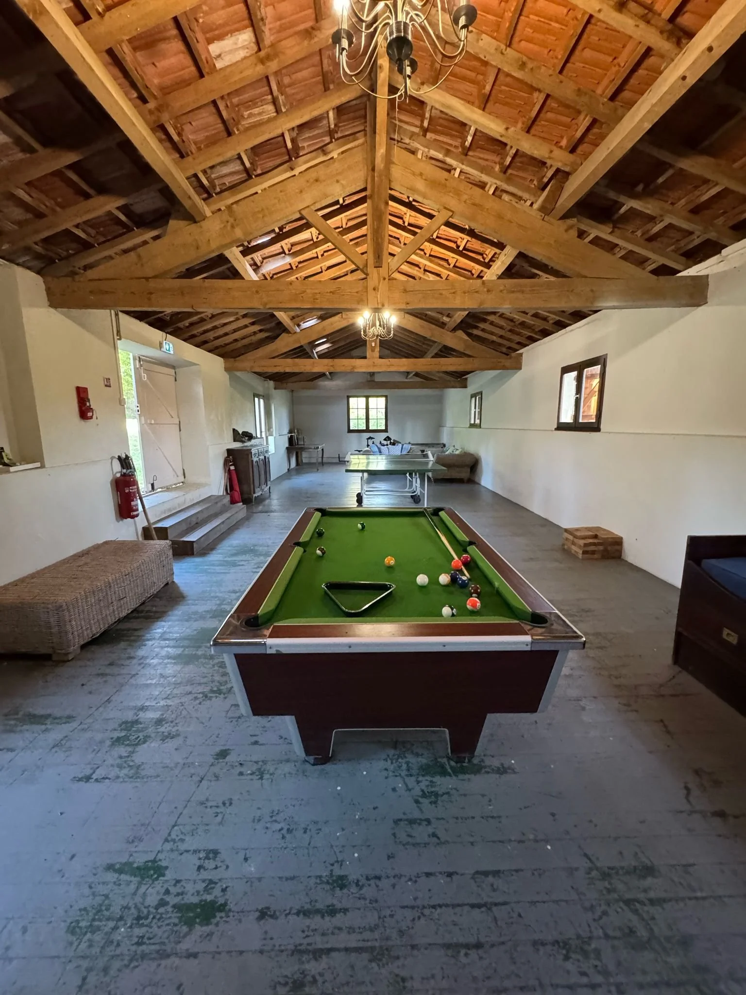 Games room at Château Lasfargues with table tennis table and children's toys, in a South West France holiday château.