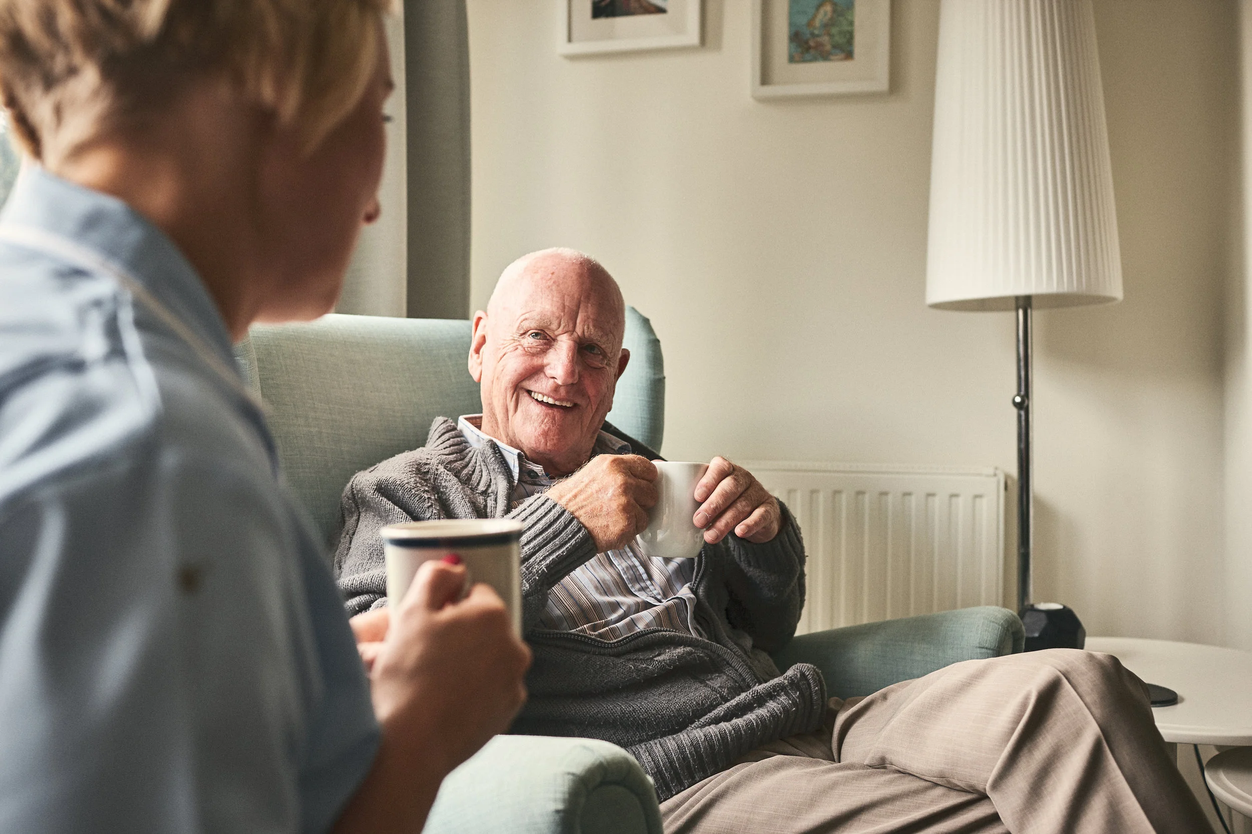 Smiling-senior-man-talking-to-female-caregiver-912073374_5616x3744.jpeg