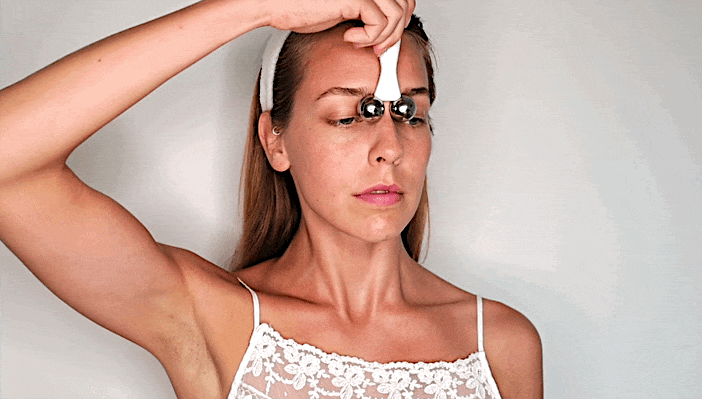 You can also roll the space between your eyebrows. Start at the tip of your nose and pull towards your hairline.