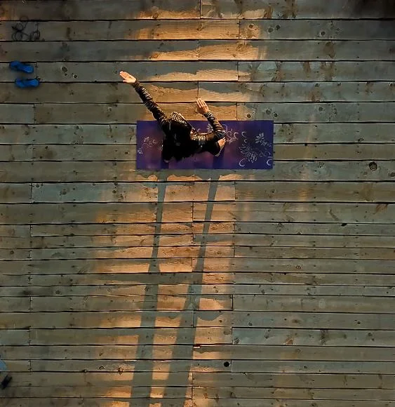 A retreat guest enjoying some Qui Gong as the sun set over the mountain
