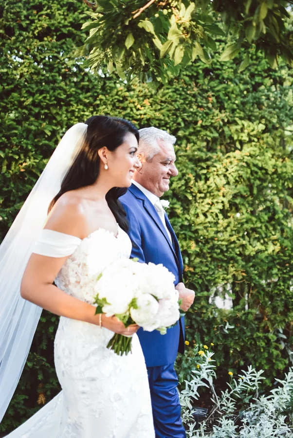 Dad walks his daughter down the aisle.