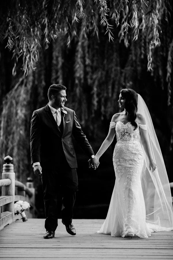 Bride and Groom hold hands at Chicago Botanic Garden.