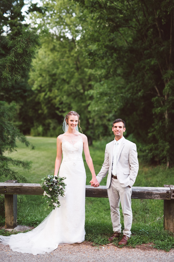 Bride and groom holding hands.