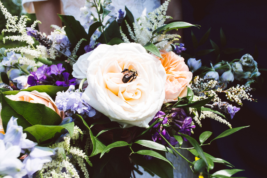 Bumble bee lands on bride's bouquet.