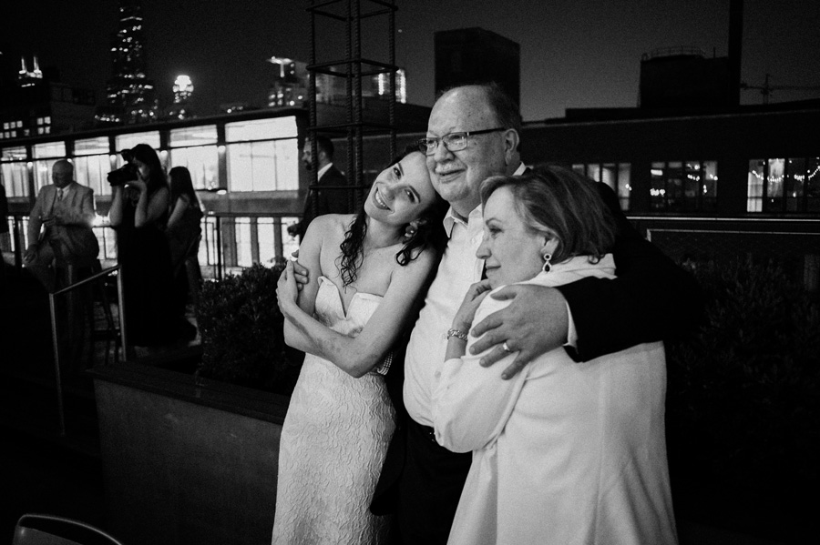 Bride and her parent watch mother son dance.