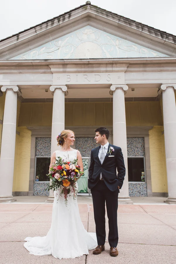 Bride and groom in front of Birds exhibit at Brookfield Zoo.