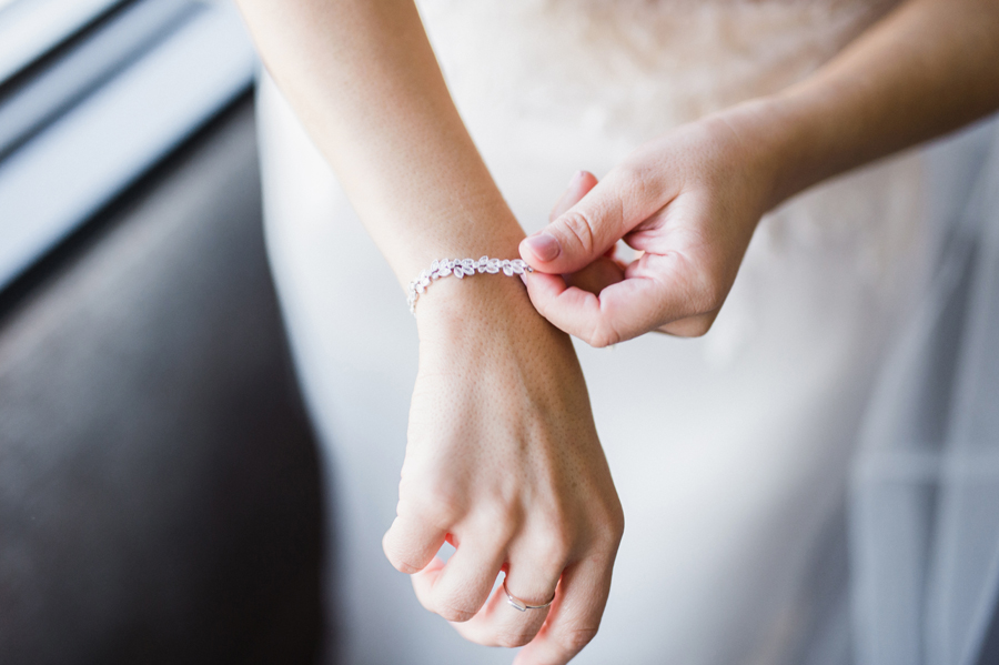 Bride puts on her bracelet.