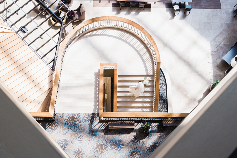 Bride walks up staircase.