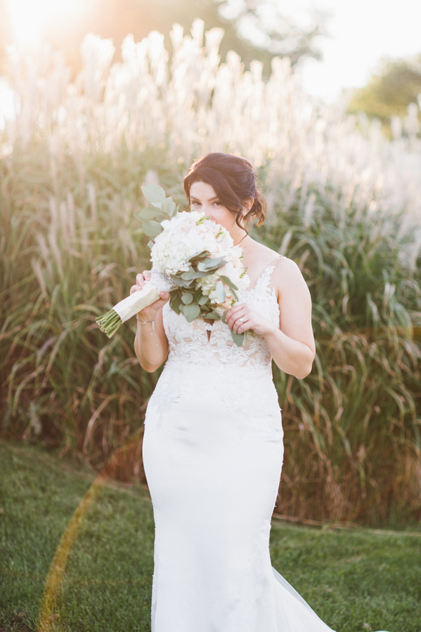 Bride smelling her bouquet.