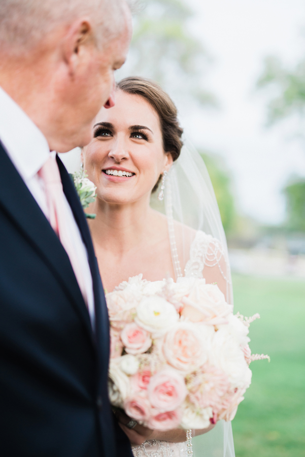 Bride looks at her dad right before wedding ceremony.