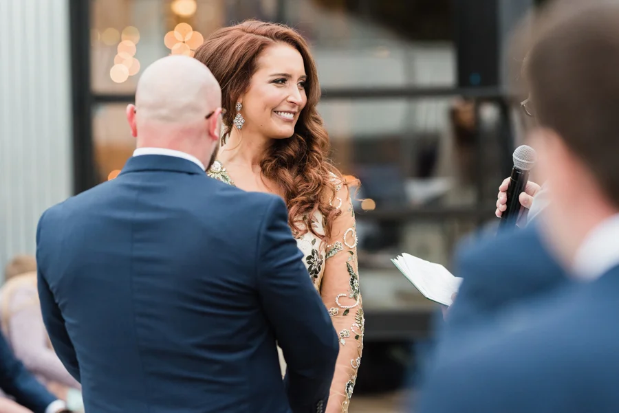 Bride reacts during wedding ceremony.