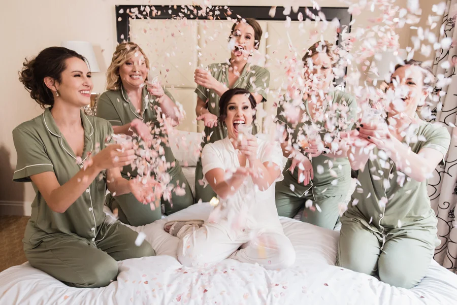 Bride and bridesmaids with confetti.