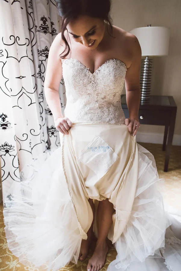 Bride with handkerchief sown onto her dress.
