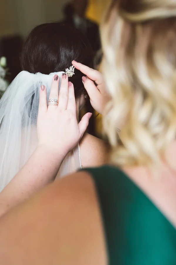 Bride gets her veil put on.