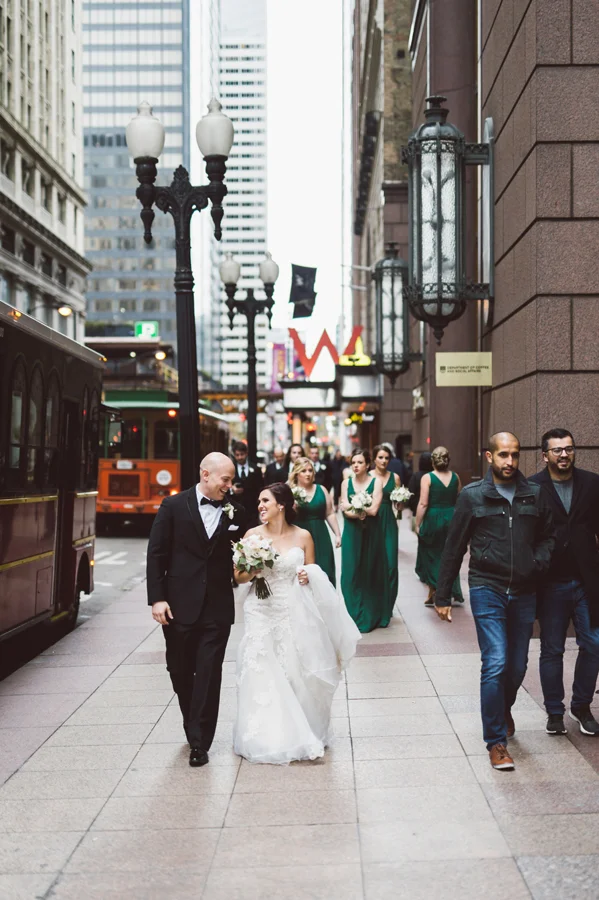 Bride and groom walk around downtown Chicago.