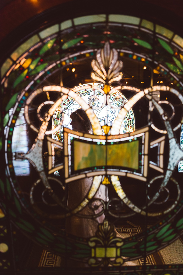Bride's portrait with stained glass windows at Pleasant Home.