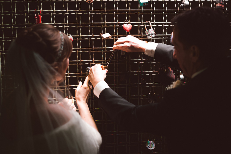 Bride and groom put up a lock in Oak Park.