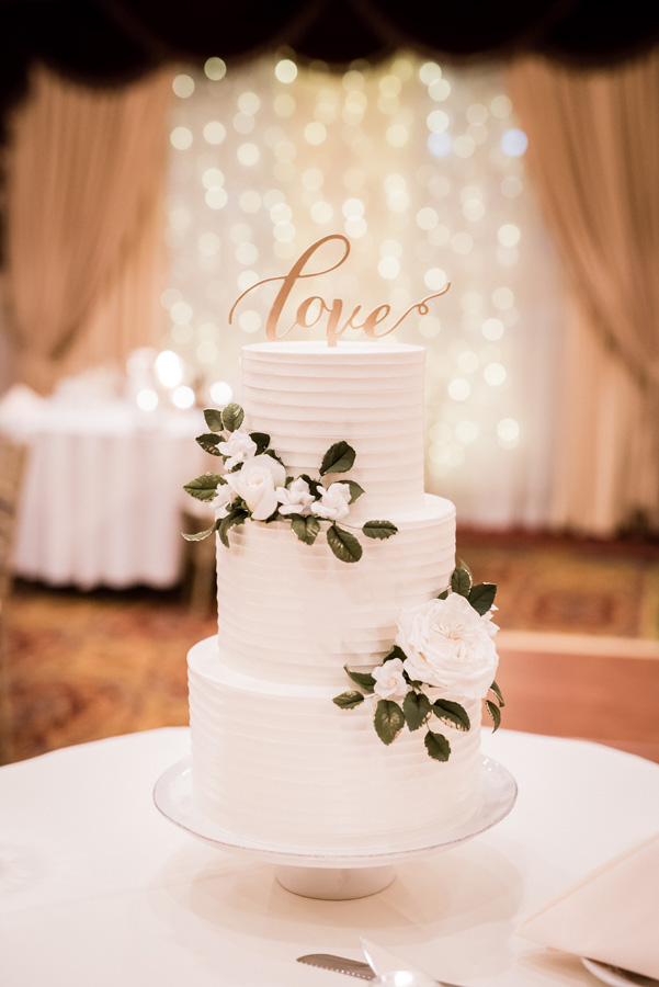 Wedding cake with "love" topper.