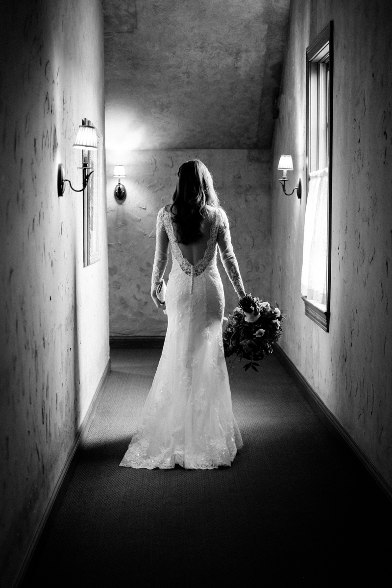 Bride walks down hallway at the Herrington Inn.