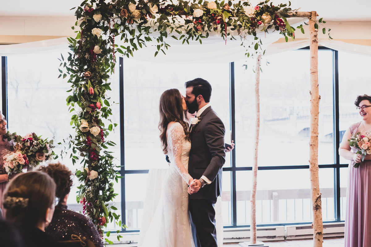 Bride and groom kiss.