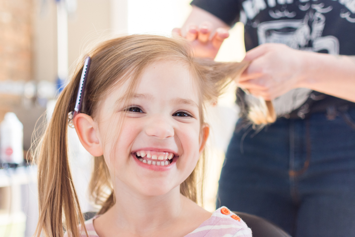 Flower girl getting her hair done.
